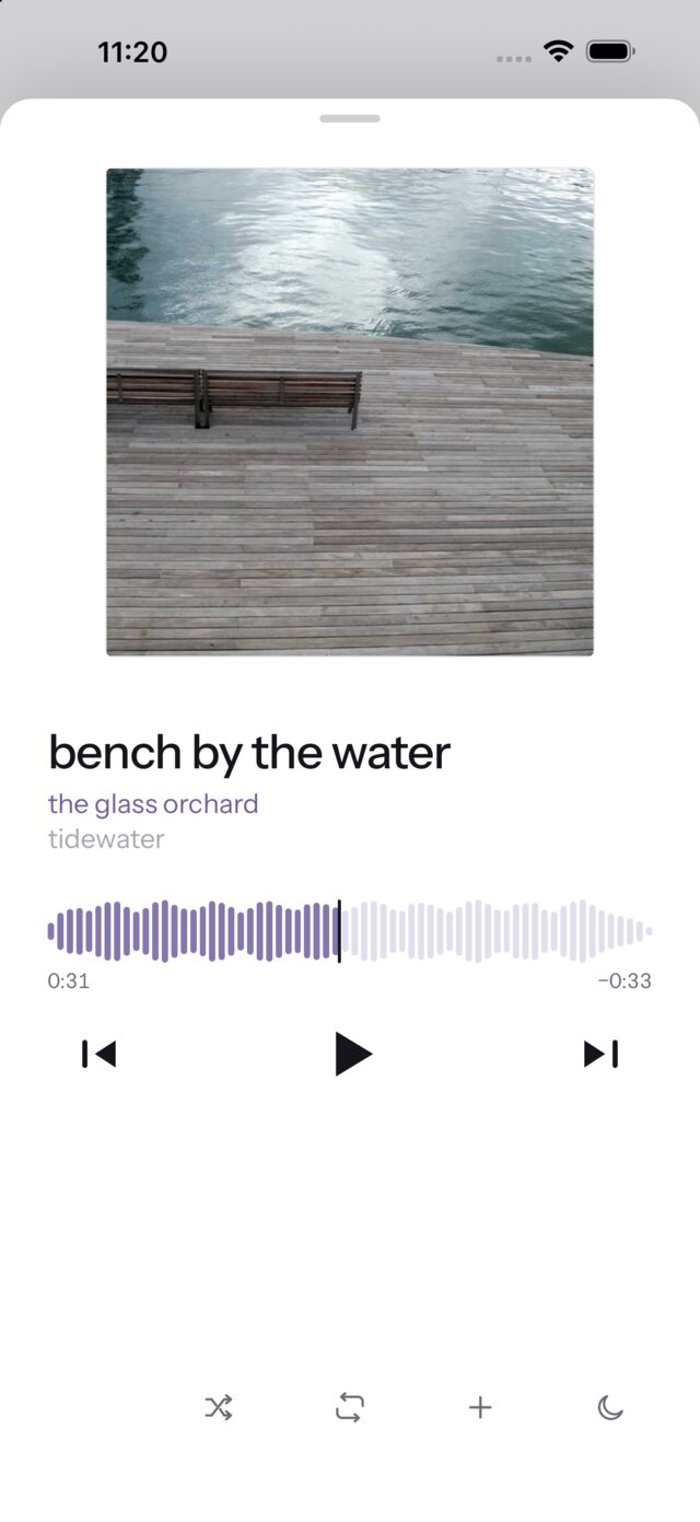 Now playing — cover art over a seek bar drawn from the track's own waveform.